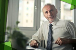 Zdjęcie do artykułu na blogu Pro-Tax. Na zdjęciu mężczyzna senior pracujący przy biurku